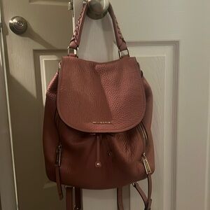 Michael kors mauve backpack. One zipper is broken. Picture attached.